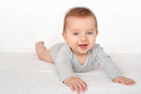 Portrait of a cute baby boy with blue eyes on white background. Healthy childhood innocence concept.の写真素材