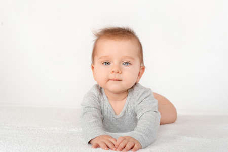 Portrait of a cute baby boy with blue eyes on white background. Healthy childhood innocence concept.の写真素材