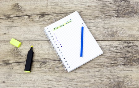 Marker pen and notebooks on wooden board written: To do listの写真素材