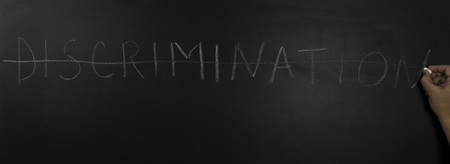 written the word on chalk:stop discrimination on blackboardの写真素材