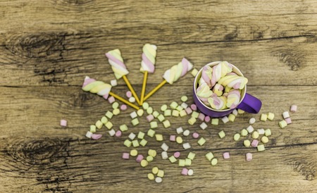 view from above at cup of marshmallows with sticks and marshmallow ballsの写真素材