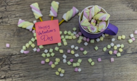 cup of marshmallows and the word written happy valentine's dayの写真素材