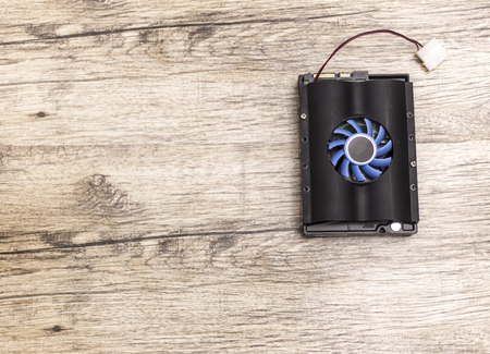 hard disk lays on dark brown wooden boardの写真素材