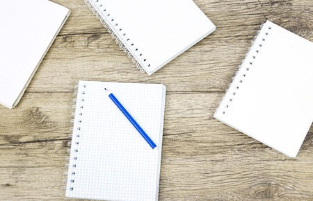 Marker pen and notebook on wooden boardの写真素材