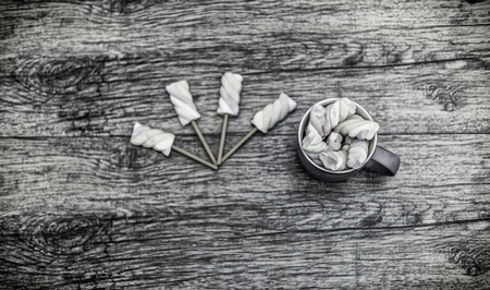 view from above at cup of marshmallows with sticksの写真素材