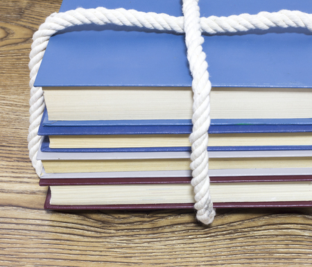 Stack of tied books on wooden tableの写真素材