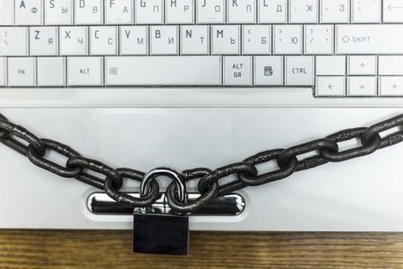 the laptop is wrapped in a chain with a padlock
