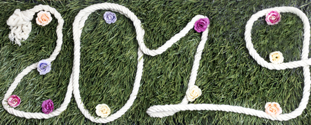 Rope in the form of the year 2019 with flowers on grassの写真素材