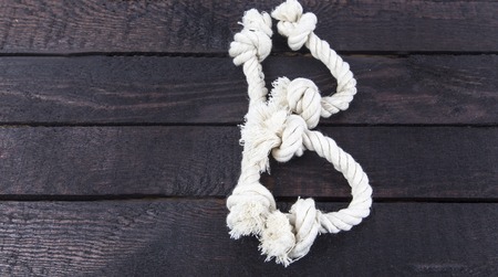 shaped the letter with rope on wooden backgroundの写真素材