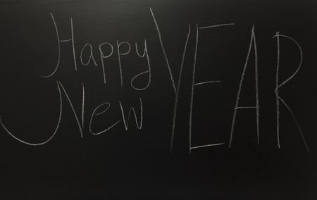 the text happy new year on black boardの写真素材