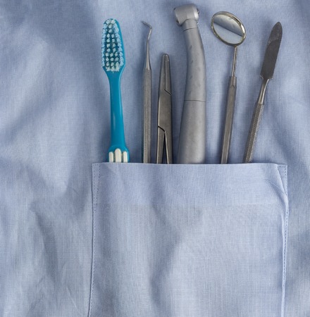 Toothbrush and dental instruments in blue pocket.の写真素材