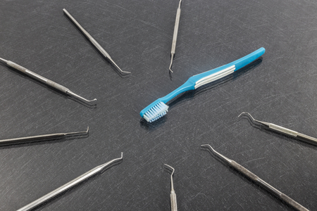 Dental care concept.Blue toothbrush with dental instruments.の写真素材