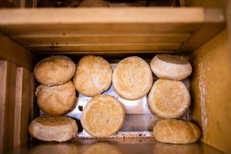 Bun in a grocery store in a wooden box. Many round bunsの写真素材