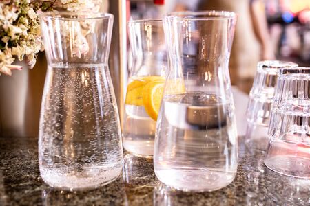 drinking water with lemon in crystal transparent jugs.の写真素材
