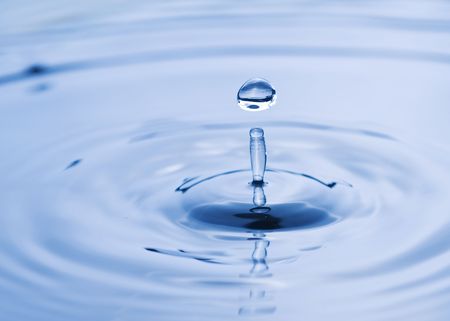 Beautiful water drop falling into water