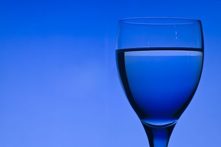 Blue background with crystal glassの写真素材