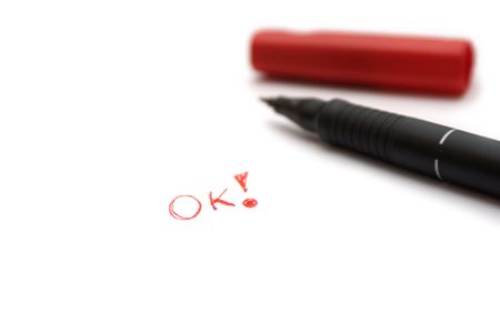 Inscription Ok on white leaf with penの写真素材