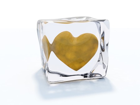 Yellow heart frozen in ice cube isolated on whiteの写真素材