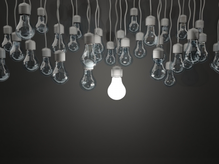 Bright light bulb on black backgroundの写真素材