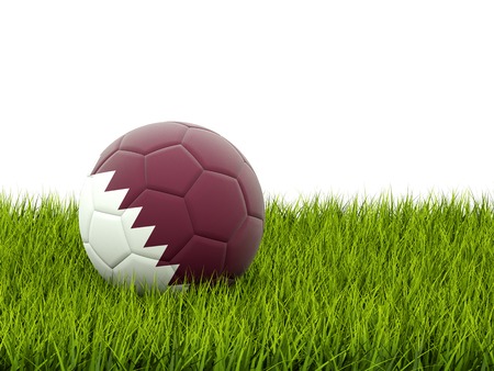 Football with flag of qatar on green grassの写真素材