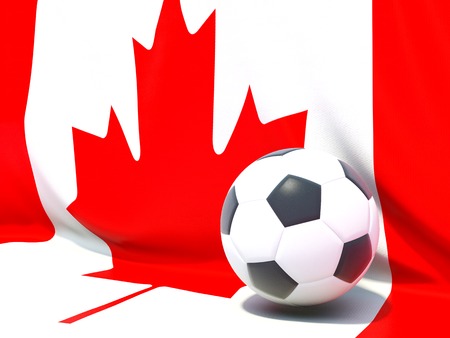Flag of canada with football in front of itの写真素材