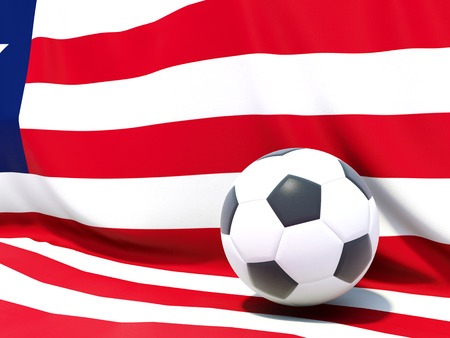 Flag of liberia with football in front of itの写真素材