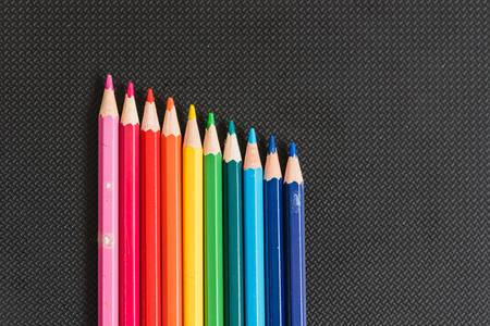 Rainbow colors pencils close up isolated on black backgroundの写真素材