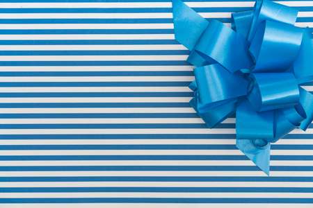 Gift box with blue and white lines and blue ribbonの写真素材