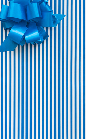 Gift box with blue and white lines and blue ribbonの写真素材