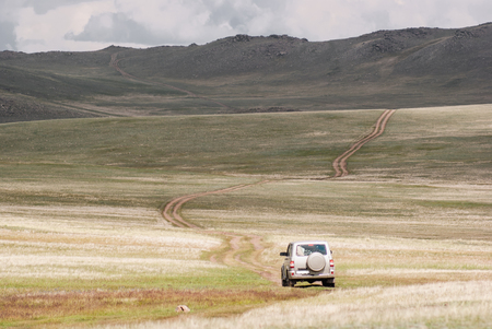 Road through the hills. Alpine scenery at Altai Mountain, central Asia. Hiking in Russiaの写真素材