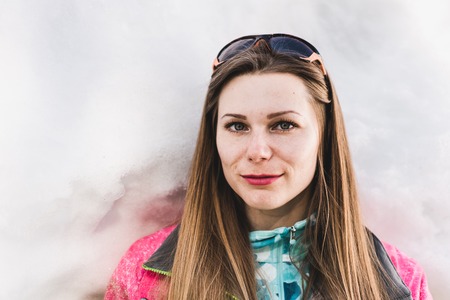 Portrait of a young pretty woman standing in front of snow wallの写真素材