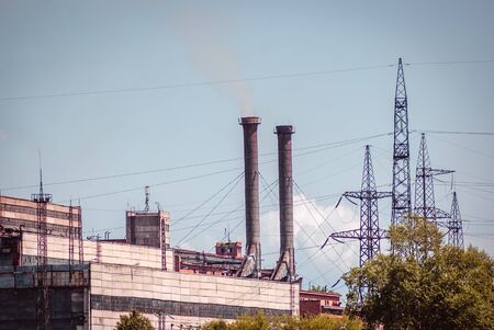 Steaming pipes at thermal power plant in the daytime