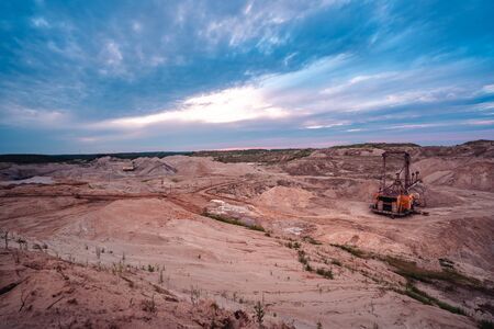 Coal mining at an open pit at sunset. Coal mine in Russia