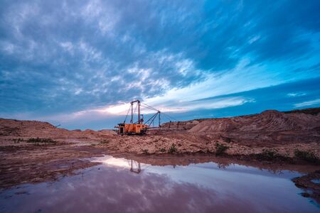 Coal mining at an open pit at sunset. Coal mine in Russia