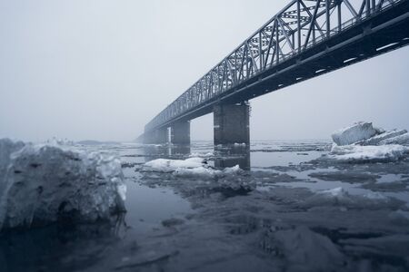Bridge through Zeya river in a snowy weatherの写真素材