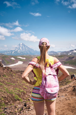 Young woman hiking to the top of the volcano. Kamchatka peninsula, Russiaの写真素材