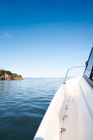 Close up of white fishing boat heading towards the ocean. Kamchatka, Russiaの写真素材