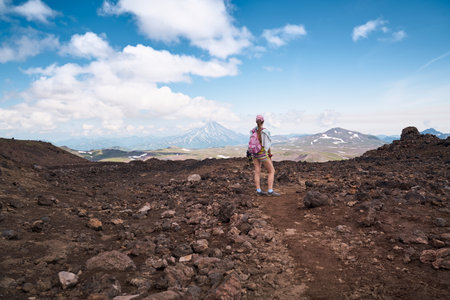 Young woman hiking to the top of the volcano. Kamchatka peninsula, Russiaの写真素材