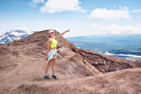 Young woman hiking to the top of the volcano. Kamchatka peninsula, Russiaの写真素材