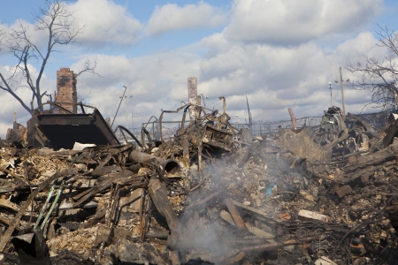 NEW YORK - October 31: Homes sit smoldering after Hurricane Sandy  in the Far Rockaway area . Over...