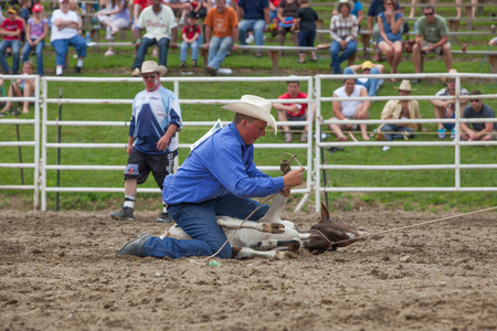 Ellicottville, New York - July 4 : Cowboy Participating Competition. Championship Rodeo, Located in the beautiful Enchanted Mountains that surround Ellicottville New York, USA on July 4 2011のeditorial素材
