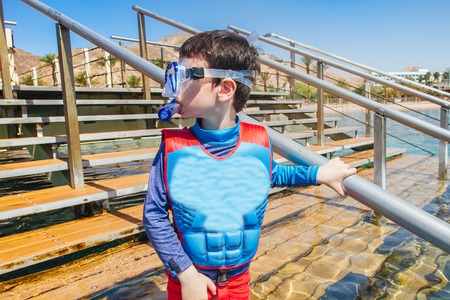 kid before Snorkeler diving along the brain coralの写真素材