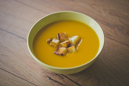 Pumpkin and carrot soup with parsleyの写真素材