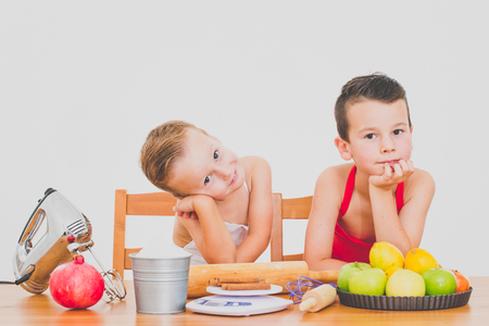happy family funny kids are preparing the apple pie , on a white backgroundの写真素材
