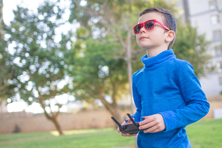 Child playing with drone outdoors at summer dayの写真素材