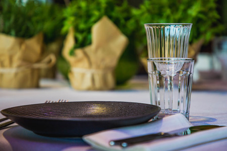 flowers on a banquet table with empty dishesの写真素材