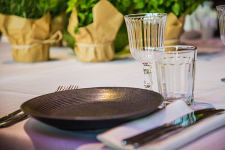 flowers on a banquet table with empty dishesの写真素材