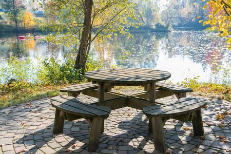 A cozy corner for relaxing in the autumn park on a bright sunny day. Golden autumn