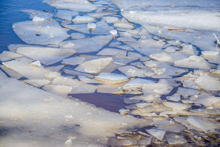 Crumbled ice on a river in spring on a cold sunny day close upの写真素材