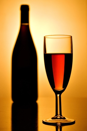 glass of red wine and a bottleの写真素材